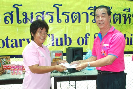 Rotary Club of Sattahip President Wirot Tuangcharuvinai presents a donation to Plutaluang’s Wat Khao Bai Sri Special Education Center.
